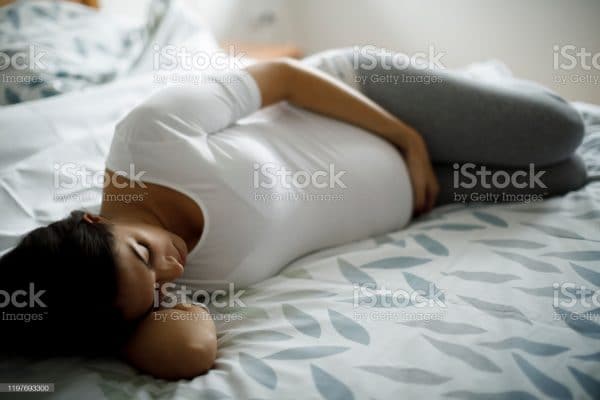 Young Pregnant Woman Lying In Bed