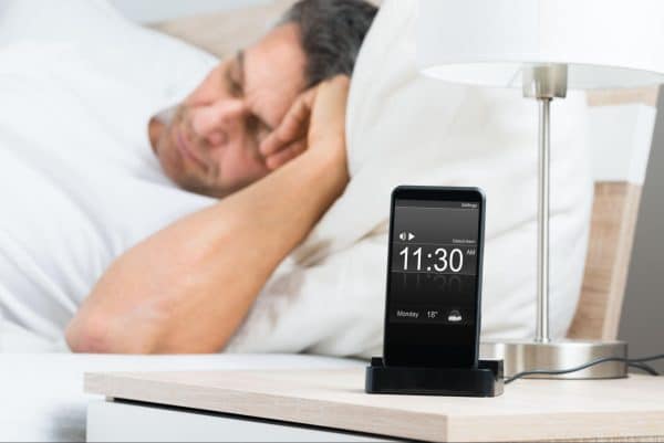 Sleeping Man With Phone Alarm Starting