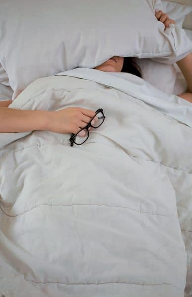 Stressed Woman Laying With Pillow On Face