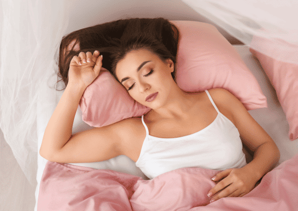 Woman sleeping on the best mattress for scoliosis